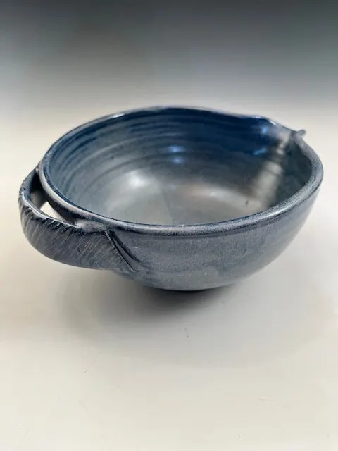 Blue stoneware batter bowl with a pulled side handle