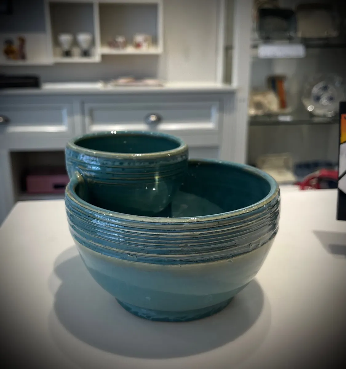 Two ribbed teal bowls nested together