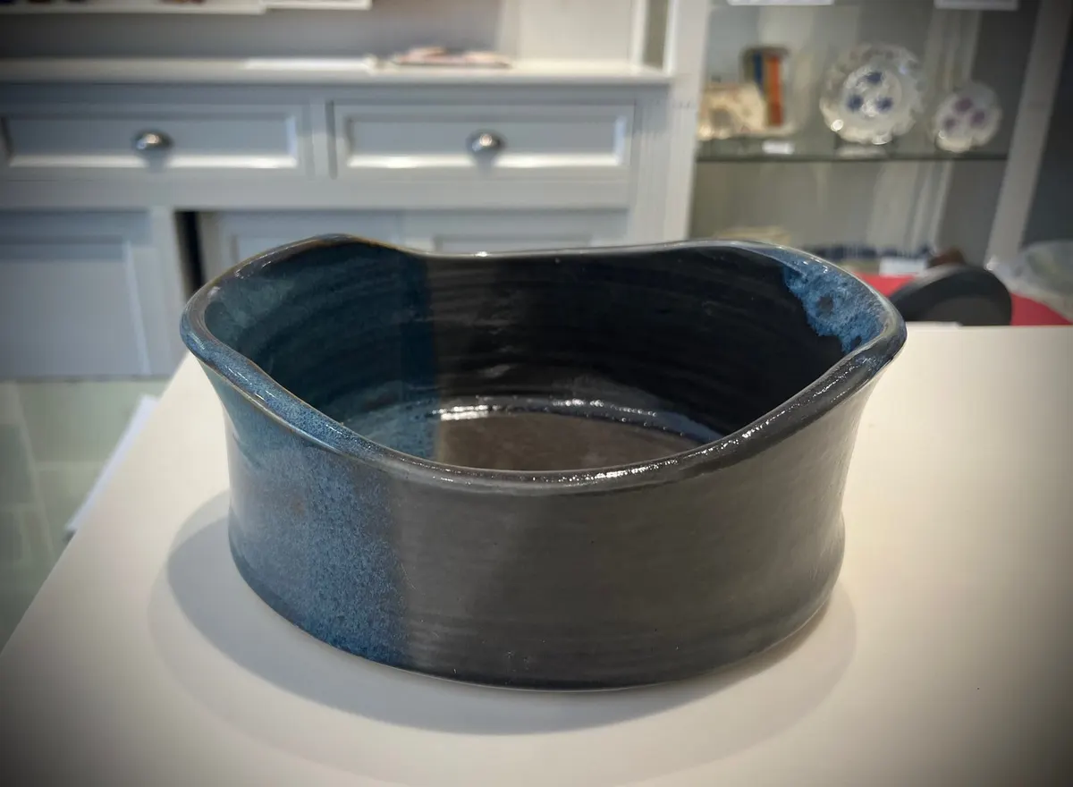 Deep blue stoneware bowl with a softly fluted rim