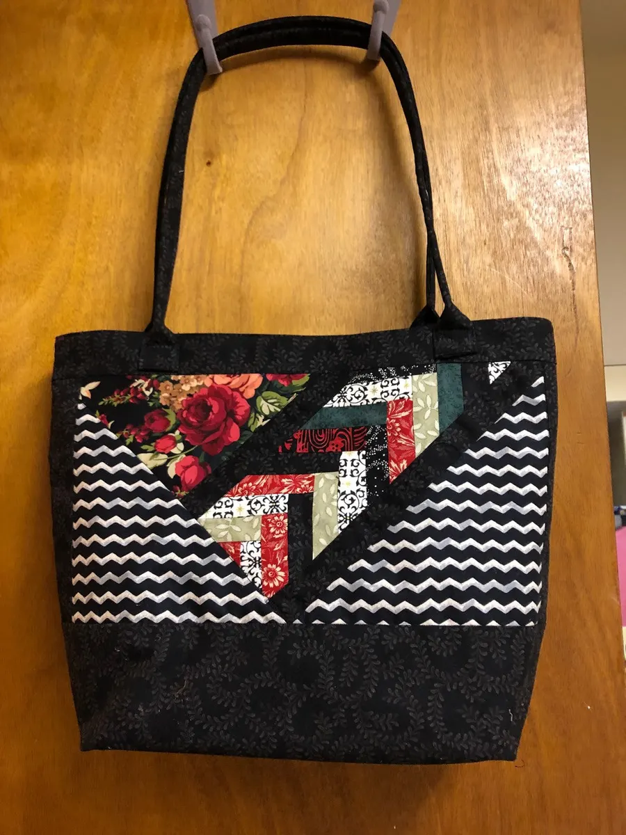 Black tote bag with a pieced floral and chevron panel