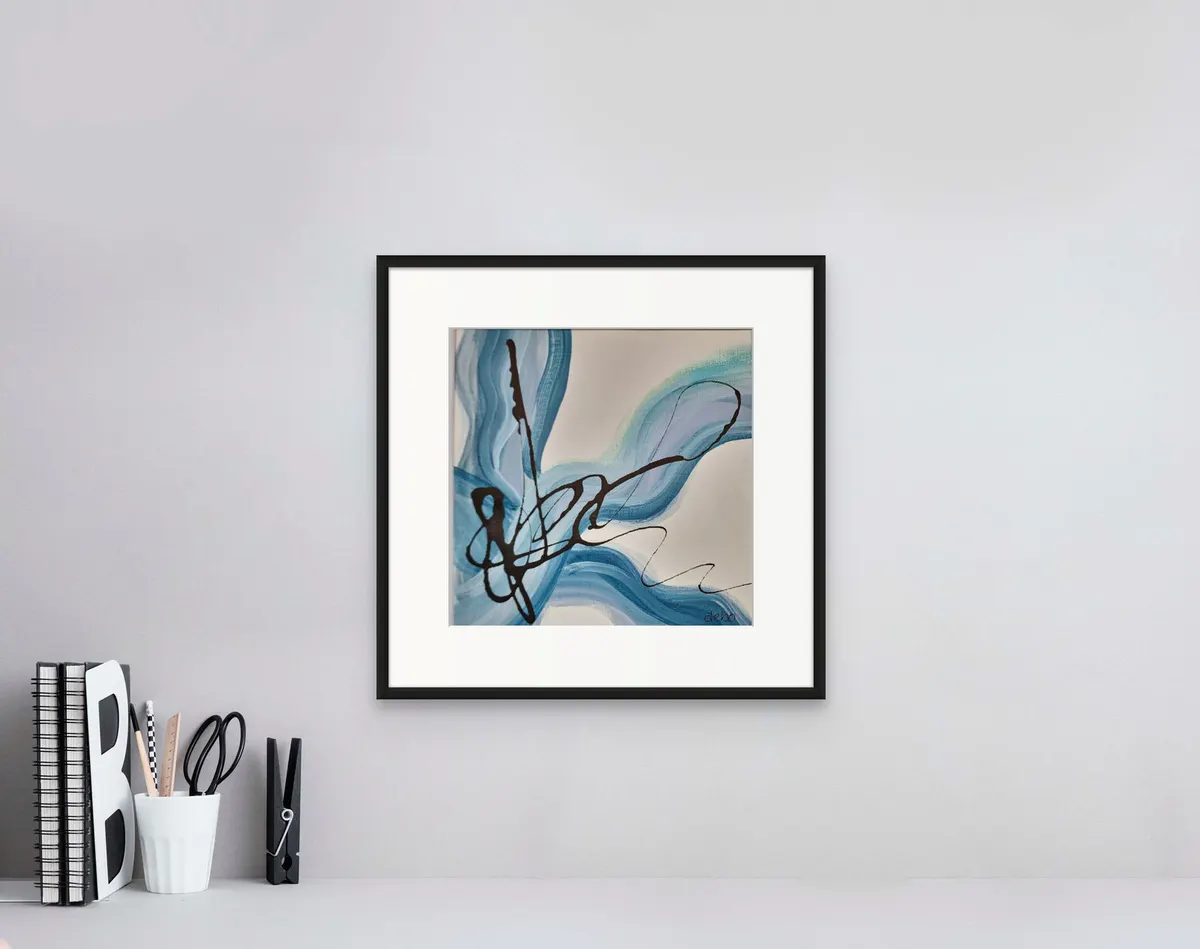Small framed abstract in blue and black brushstrokes above a desk