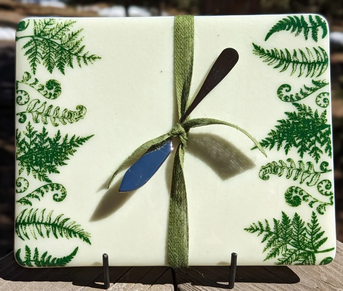Cream fused glass panel with green ferns and a ribbon-tied dragonfly