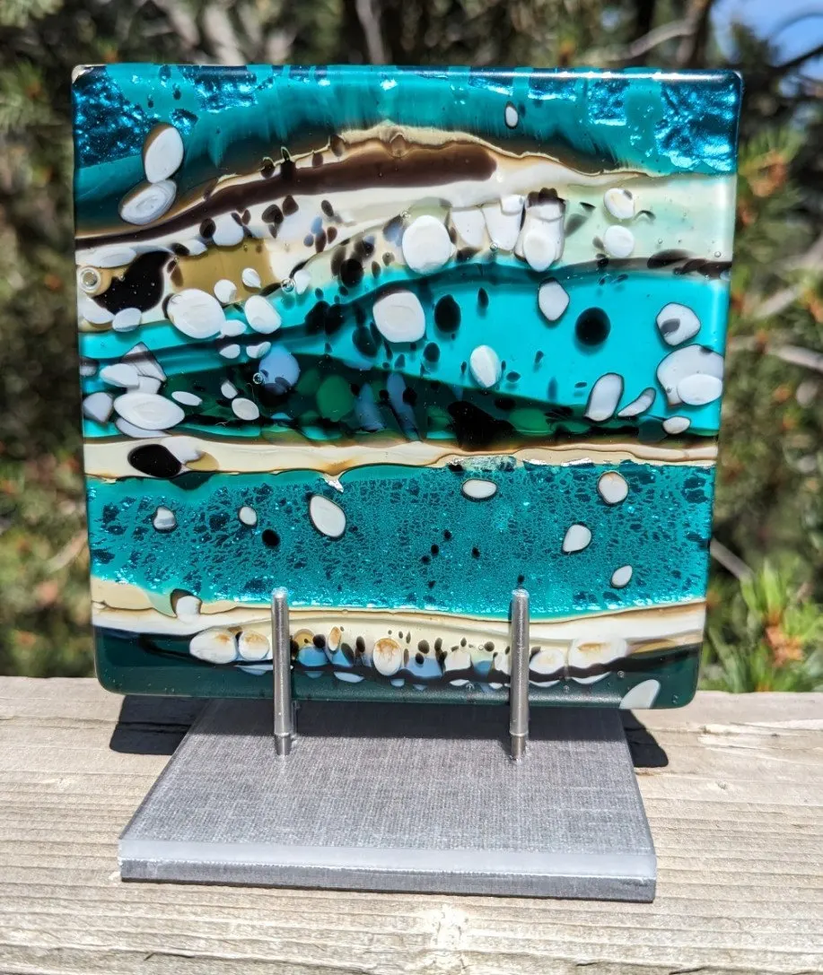 Upright fused glass panel in layered turquoise, cream and black