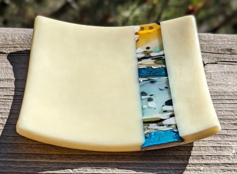 Cream fused glass dish with a central band of turquoise and gold pattern