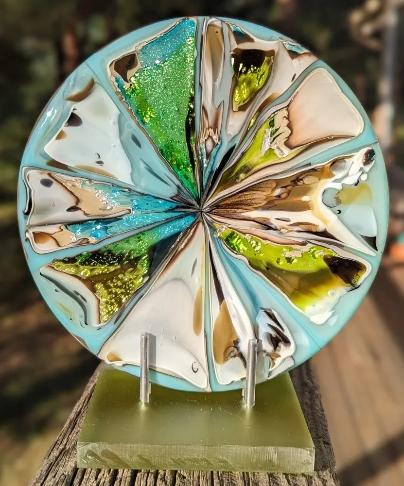 Round fused glass plate with radiating teal, green and cream segments