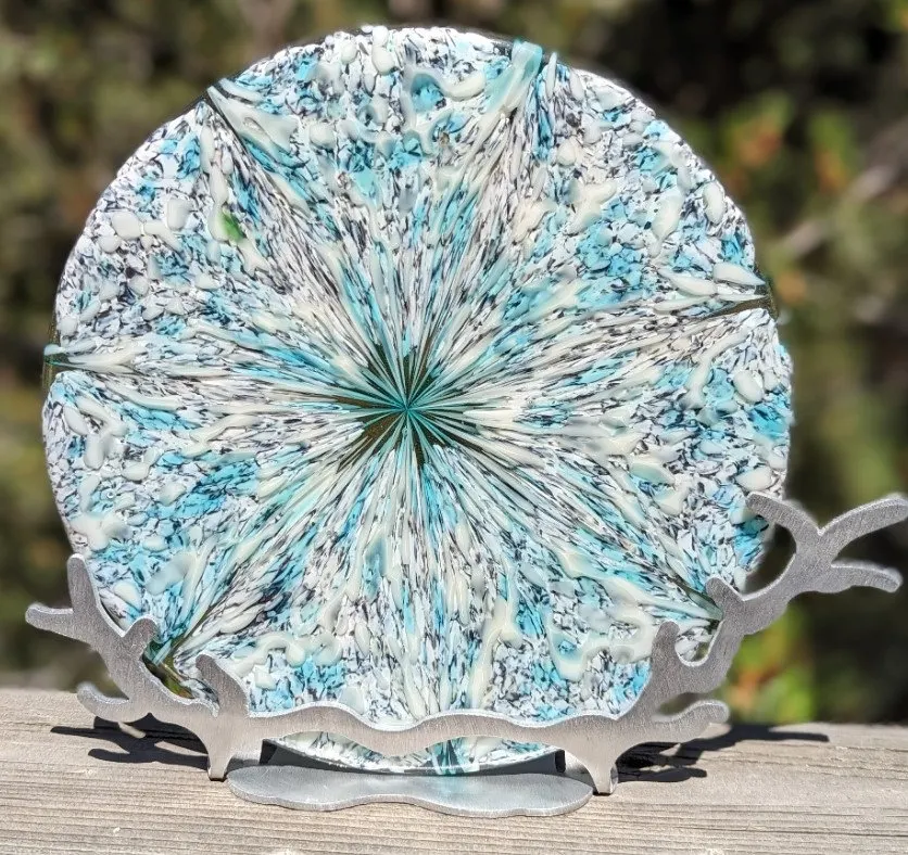 Round fused glass plate in speckled blue and white with a metal stand