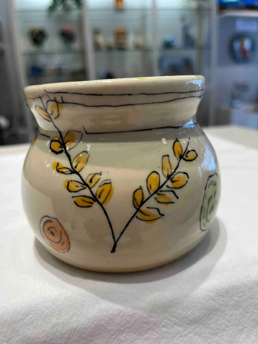 Round cream pot painted with yellow leaves on a curving branch