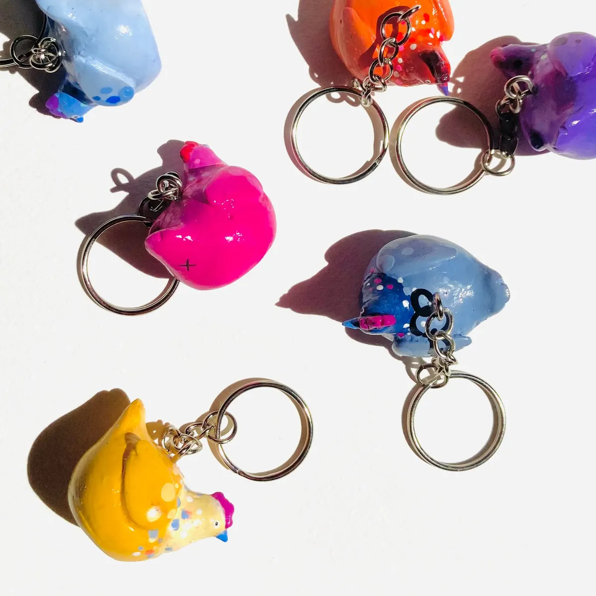 Group of small painted bird keychains in bright colours