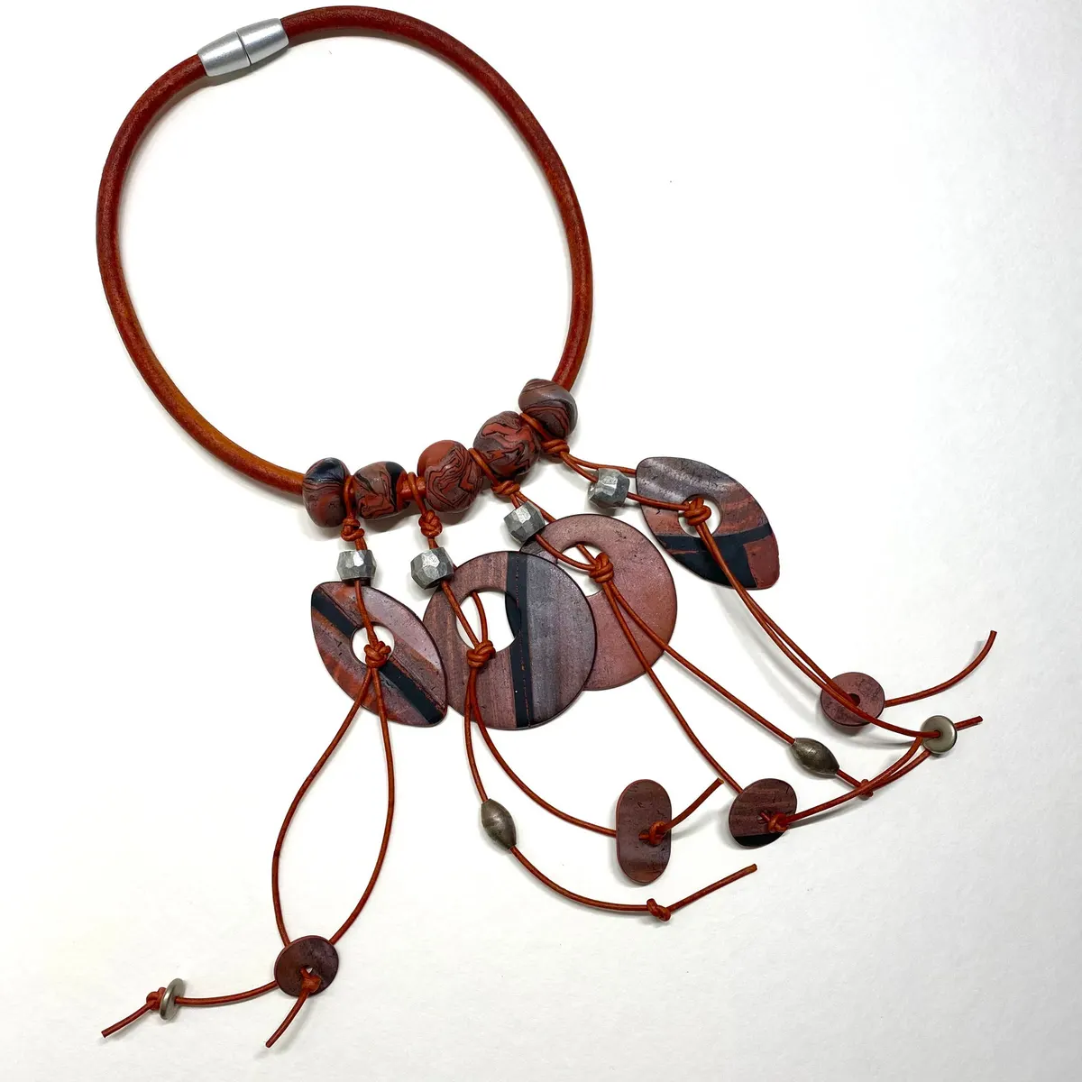 Multi-strand necklace of red-brown polymer clay beads and discs