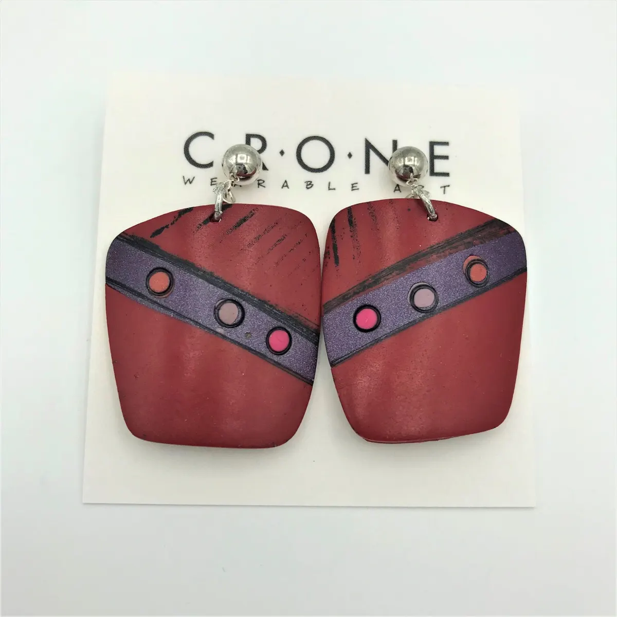 Pair of deep red polymer clay earrings with purple and pink dot detail