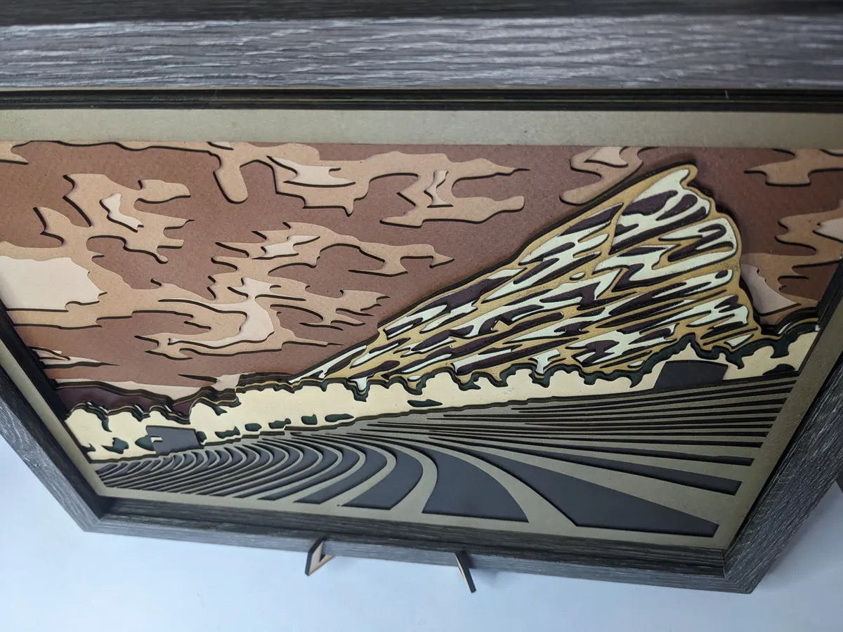 Layered laser-cut mountain landscape in brown, cream and grey