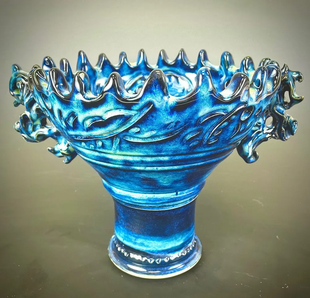 Footed vessel with a flared, ruffled rim in deep blue