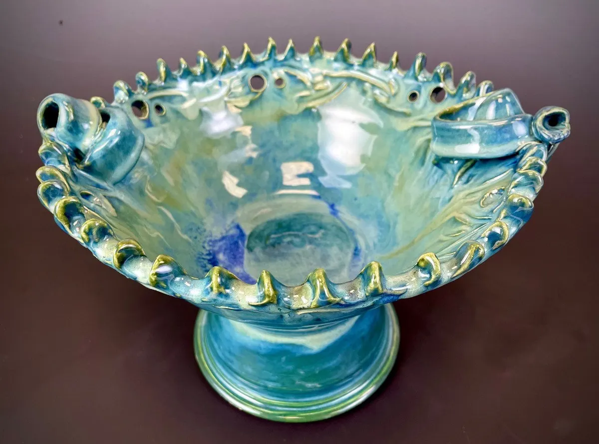 Low footed bowl with a crimped rim in turquoise and green
