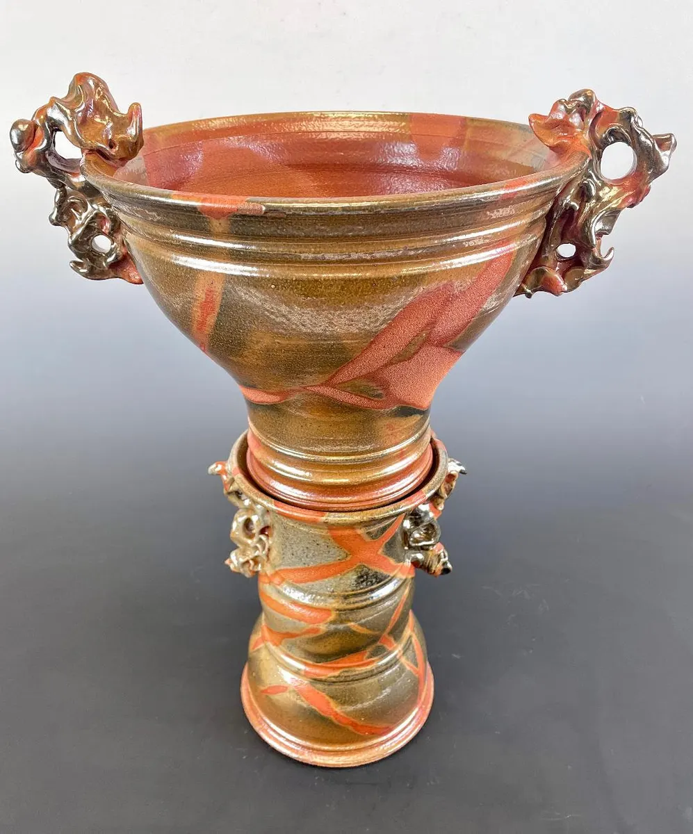 Tall goblet-form vessel with sculpted handles in amber and pink