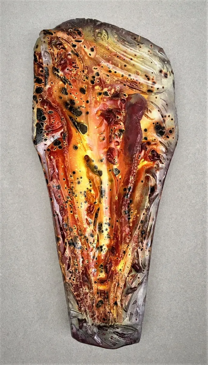 Elongated flat wall piece in amber, red and black
