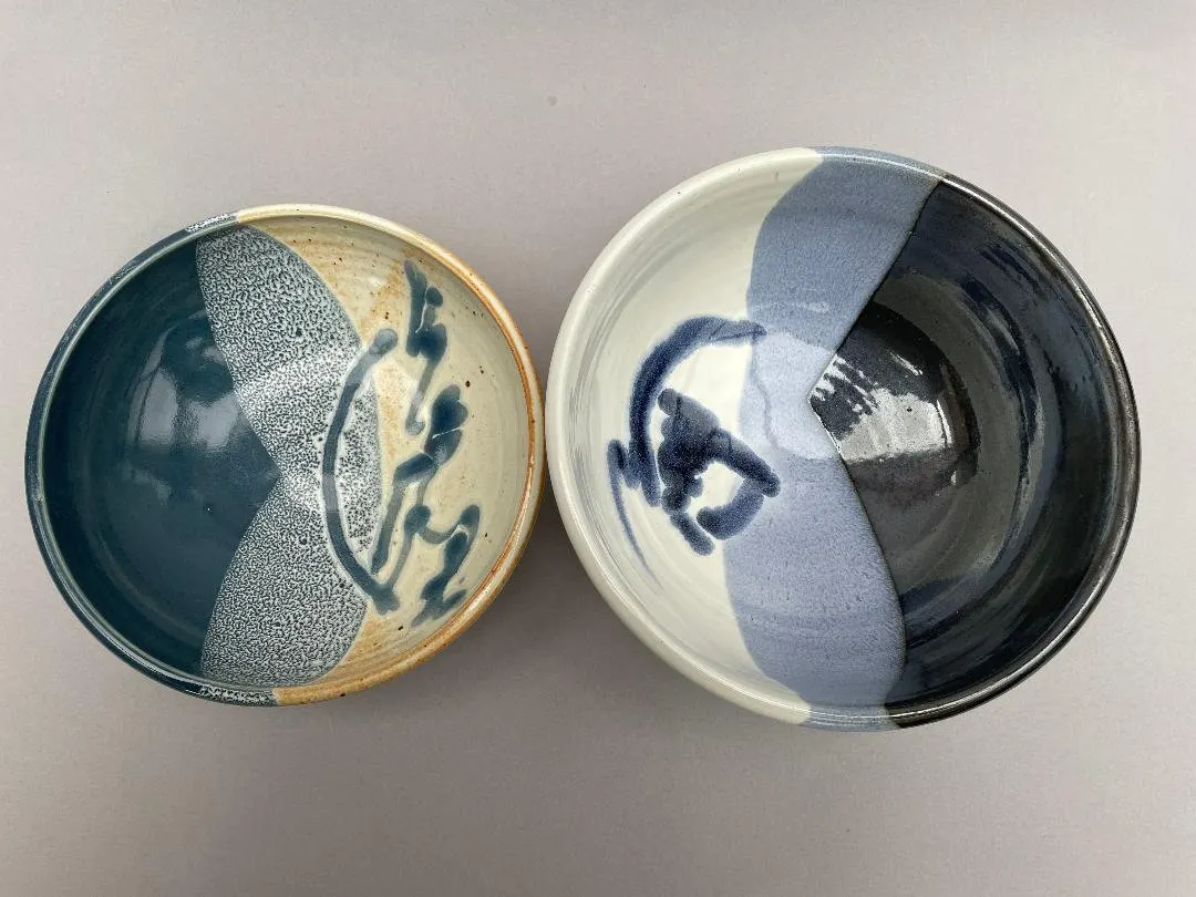 Two bowls in teal and navy with pale brushed bands