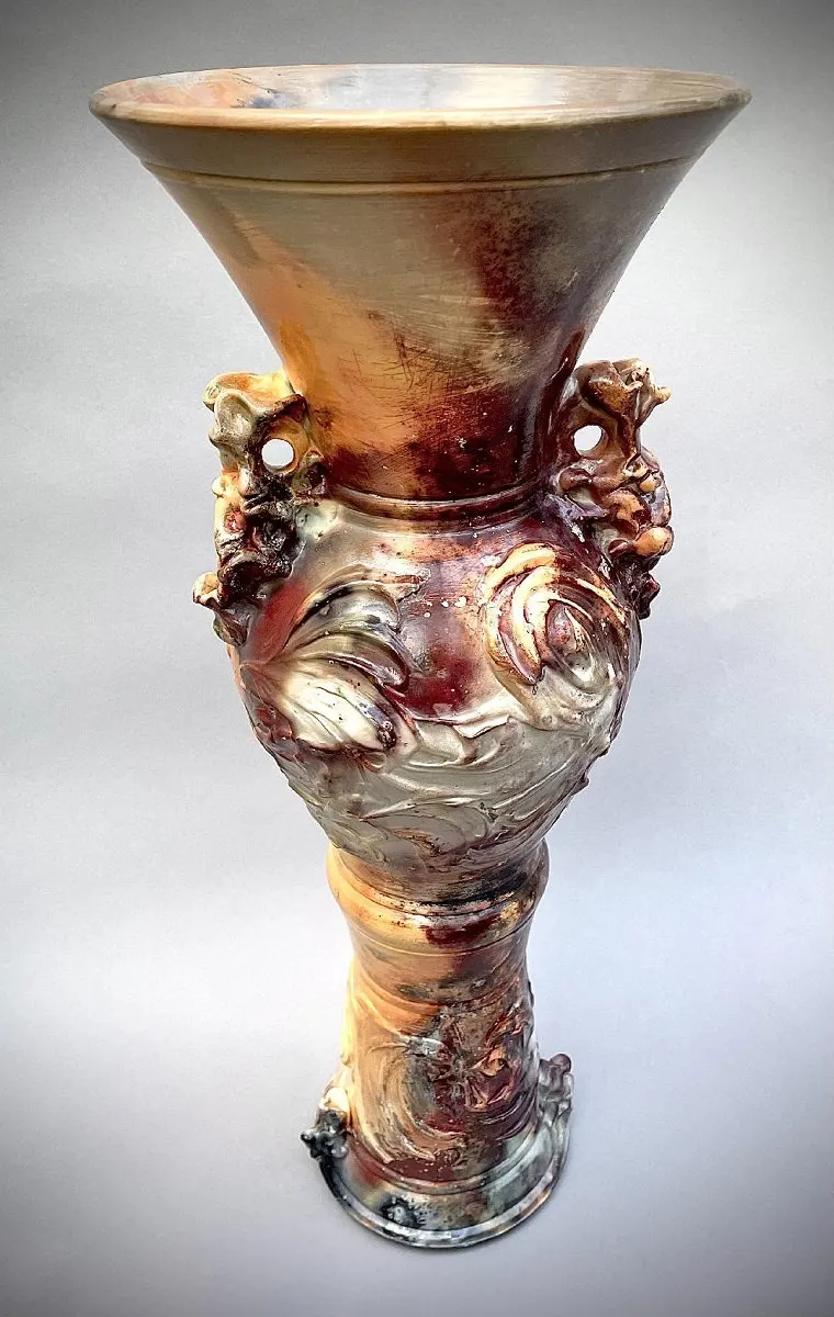 Tall flared vessel in cream and rust with applied spiral ornament