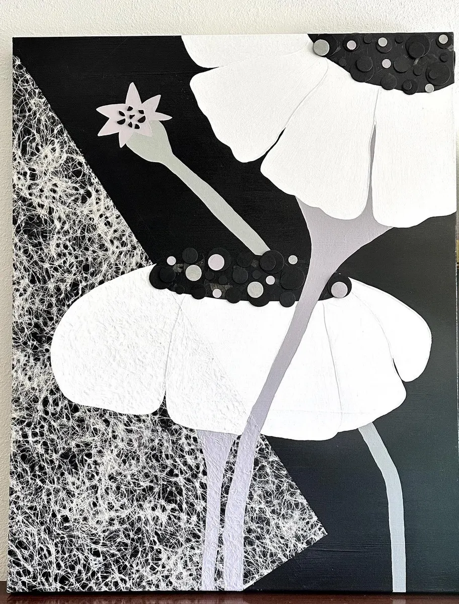 Black and white poppy painting with dotted petals and a pale stem