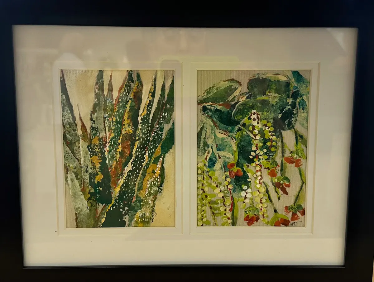 Framed pair of green and gold botanical paintings under glass